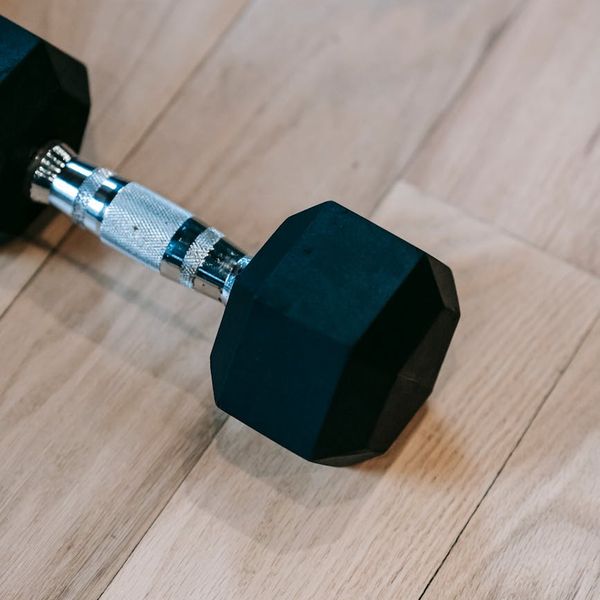 Minimalist exercise equipment on a dark wooden floor.
